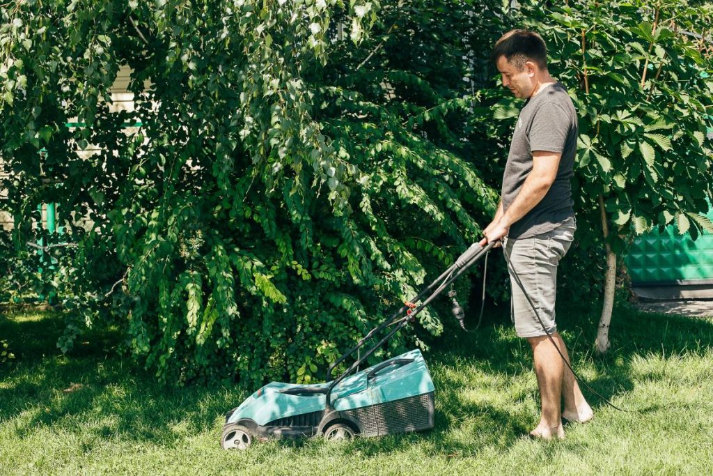 caucasian man cutting the grass with lawnmower su 2023 11 27 05 02 47 utc 1